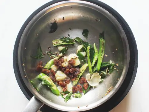 fry raisins and cumin to temper chivda