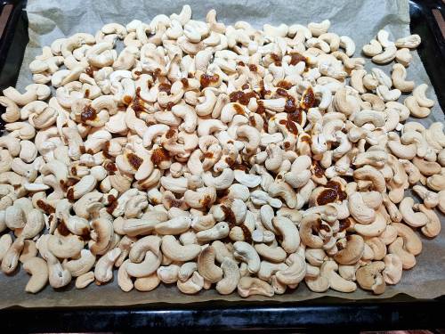 add the spices and oil to the cashews