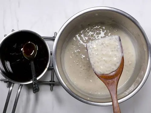 cooled payasam in a pot with jaggery cooling on the side