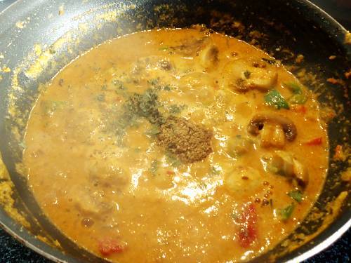 adding spice powders to simmering gravy