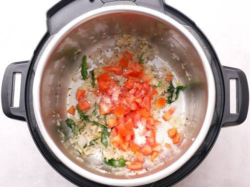 add tomatoes and salt to Instant pot to make aloo curry