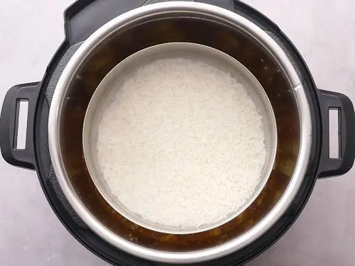 soaked rice with hot water in a bowl