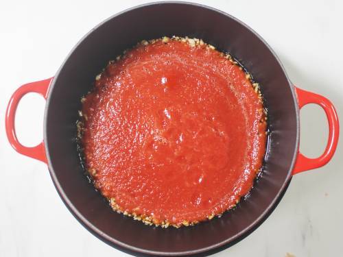 pour tomato puree to pan