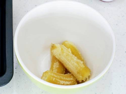 mash bananas in a bowl for bread