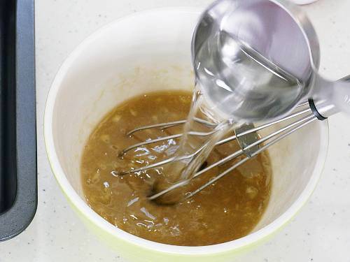 pouring water to make banana bread batter