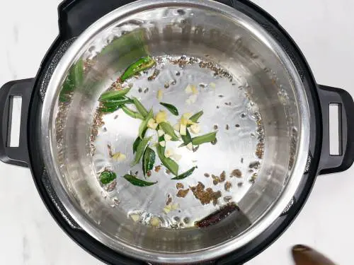 frying spices in ghee to make dal