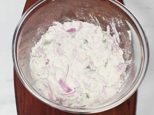 mixed ingredients in a bowl to make maddur vada