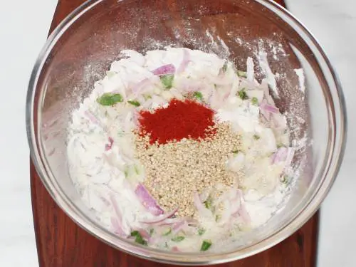 red chilli powder sesame seeds in a mixing bowl