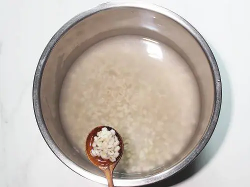 soft cooked barley in a pot of water