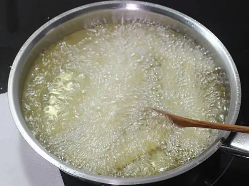 deep frying french fries in a pan