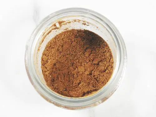 ground cumin in a glass jar