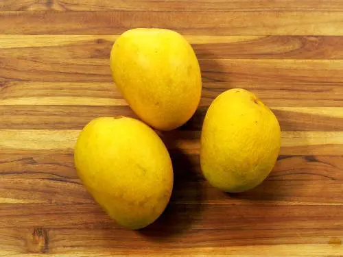 alphonso mangoes on a chopping board
