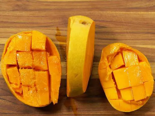 cubed mangoes on a board