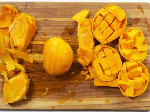 chopped alphonso mangoes on a board