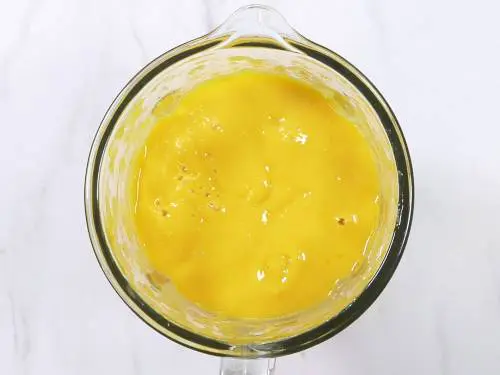mango smoothie in a glass blender jar