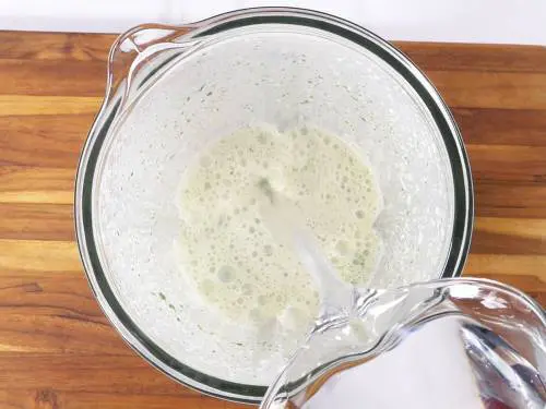 pour water to spiced yogurt to make pudina chaas