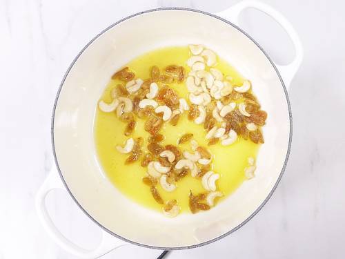 frying cashews and raisins in ghee