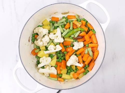 frying vegetables in ghee for biryani