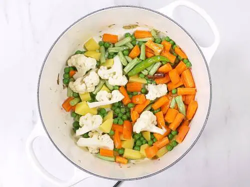 frying vegetables in ghee for biryani