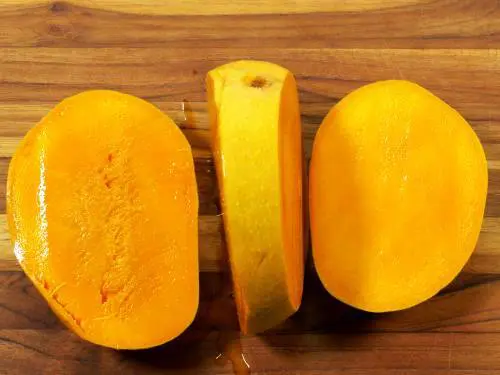 2 halves of a cut mango
