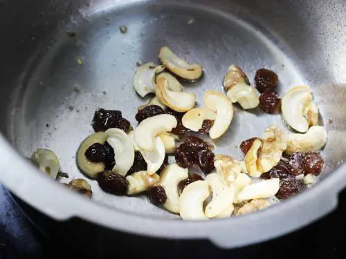 frying cashews and raisins for kashmiri pulao
