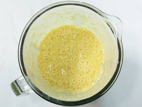 smooth creamy and delicious orange banana smoothie in a blender