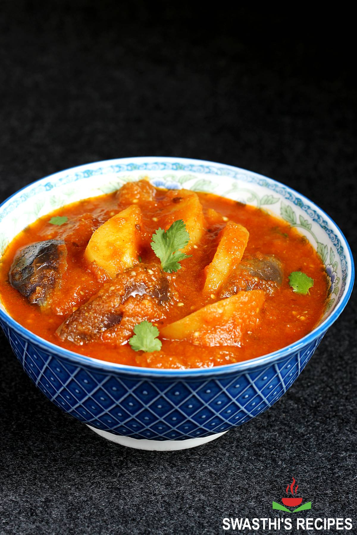 aloo baingan gravy served in a blue bowl