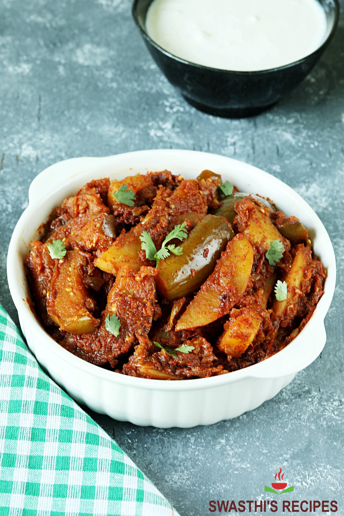 aloo baingan served in a white bowl