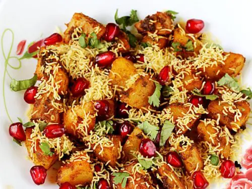 aloo chaat garnished with crunchy sev and pomegranate arils