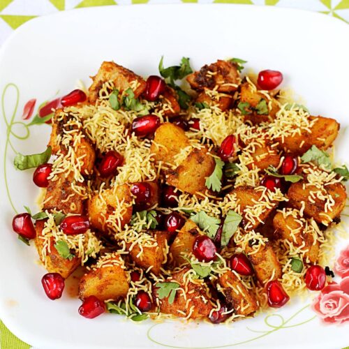 aloo chaat garnished with crunchy sev and pomegranate arils