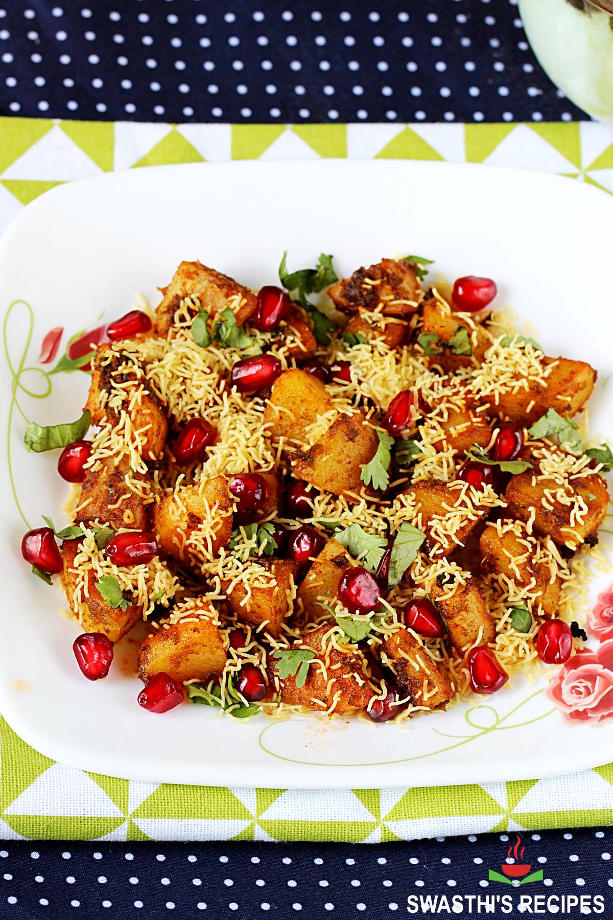 aloo chaat garnished with crunchy sev and pomegranate arils