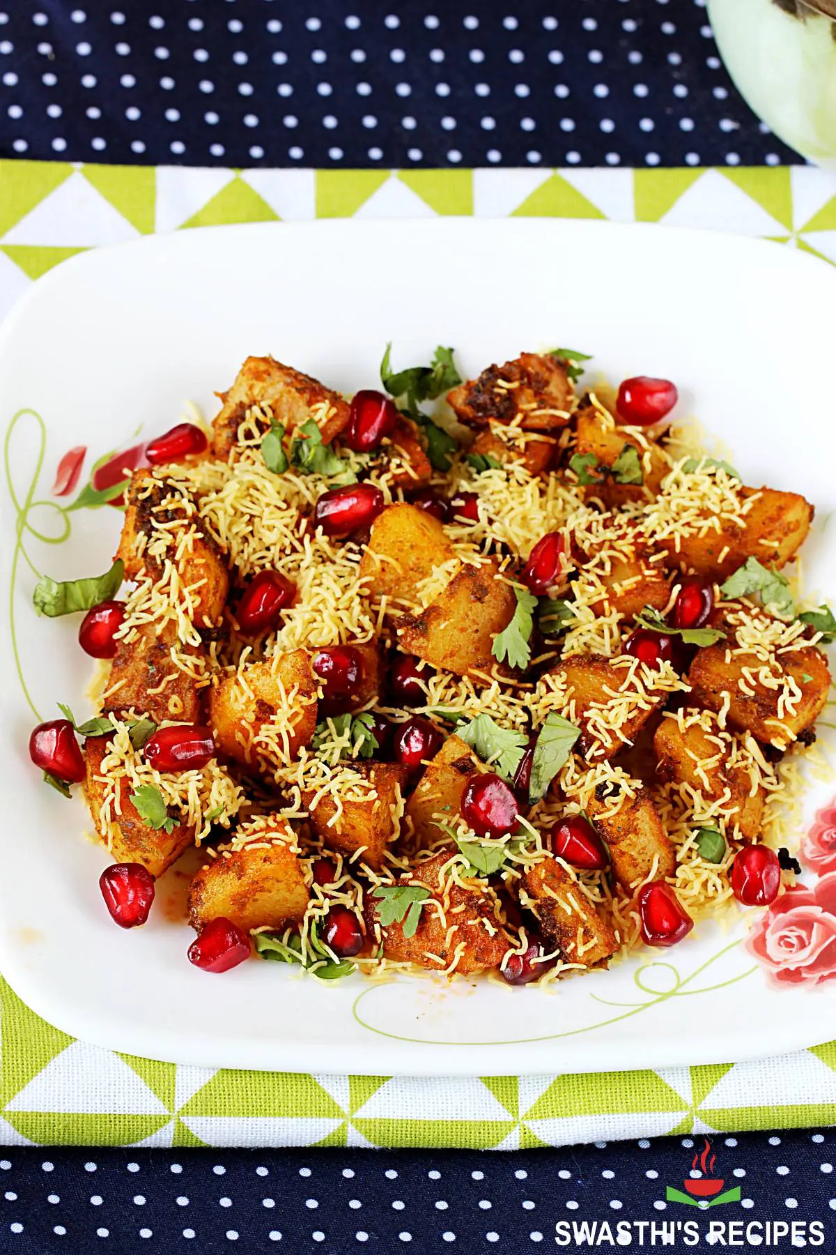 aloo chaat garnished with sev and pomegranate arils