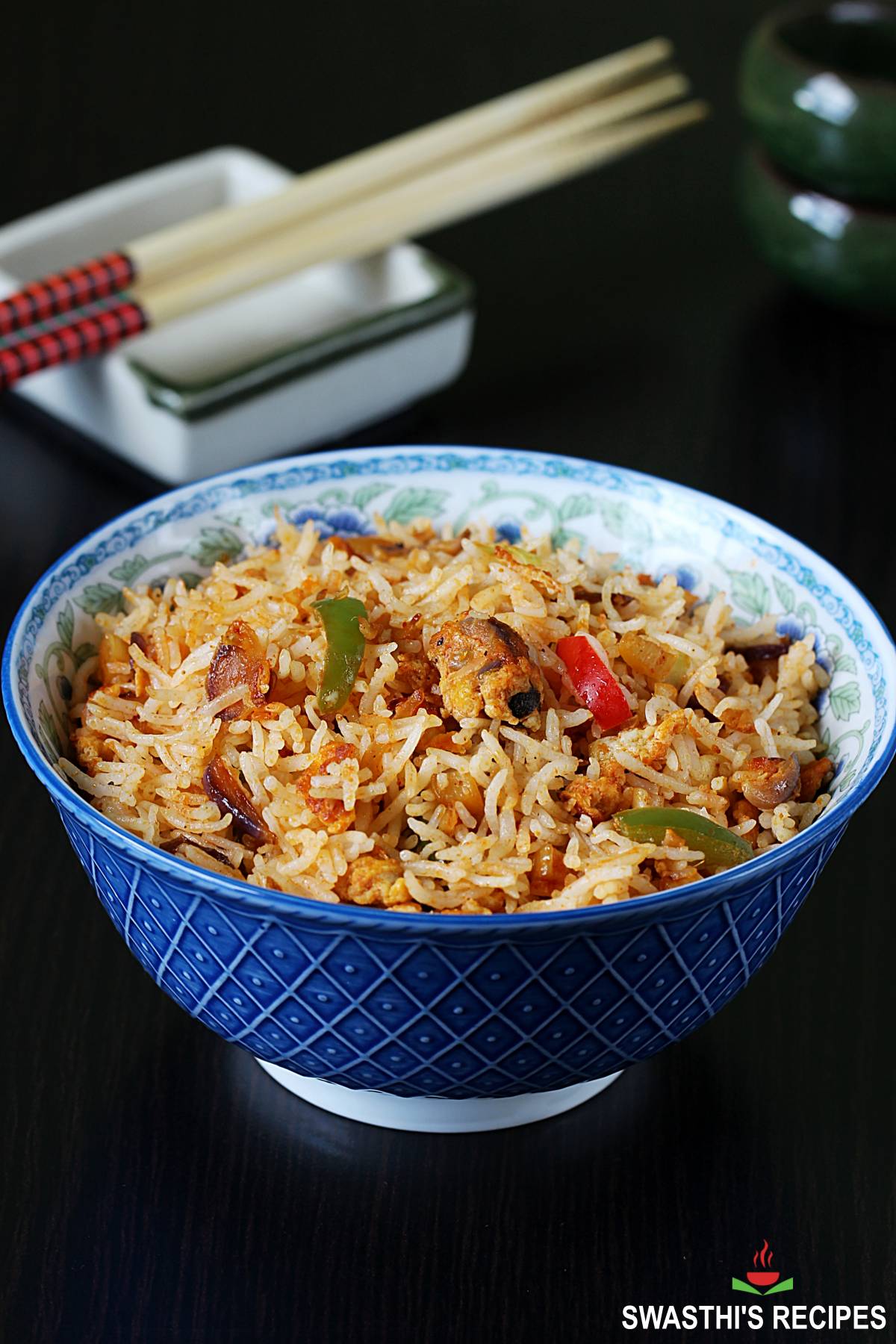 spicy egg fried rice served in a blue bowl