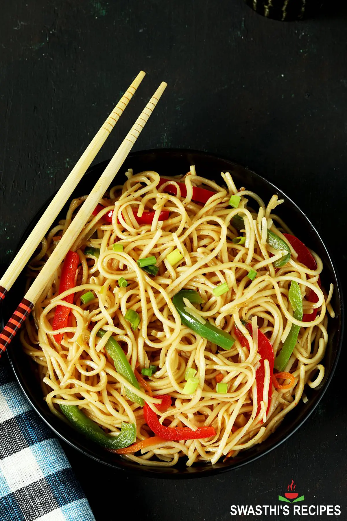 hakka noodles served in a black plate