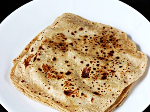 paratha served with chutney and vegetables