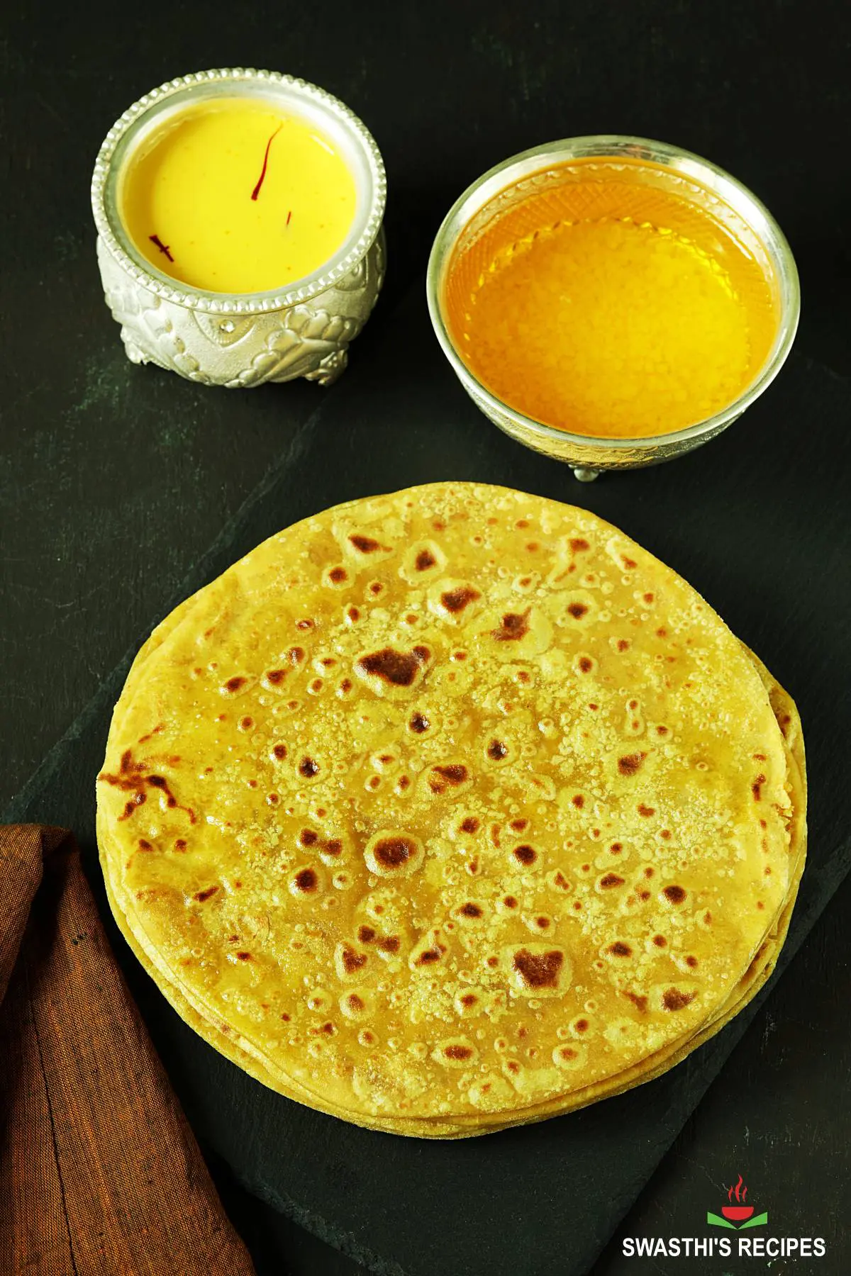 puran poli served in a black plate