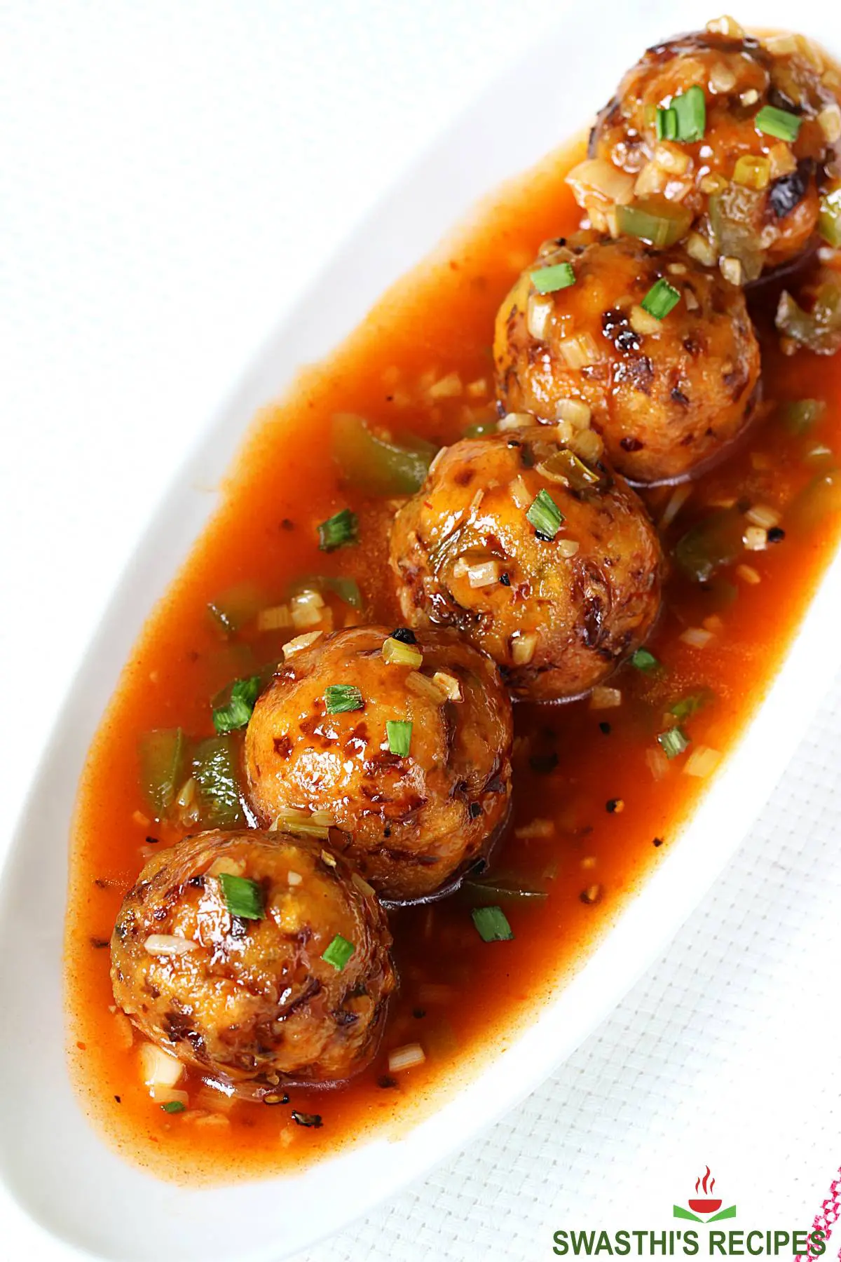 veg manchurian served in a white plate