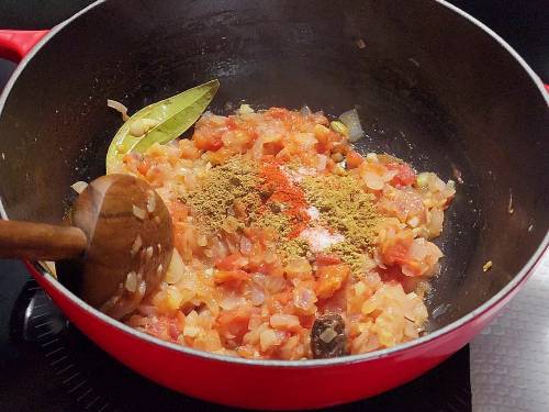 adding ground spices to make onion tomato masala