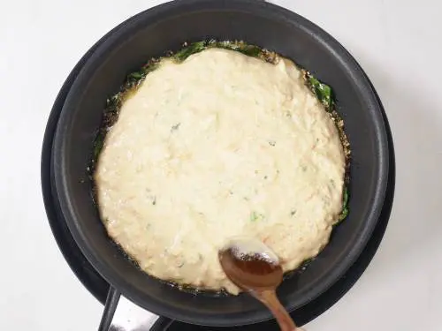 spread the handvo batter all over the pan