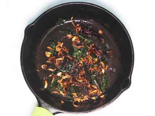 brown onions in tempering to make kadala curry