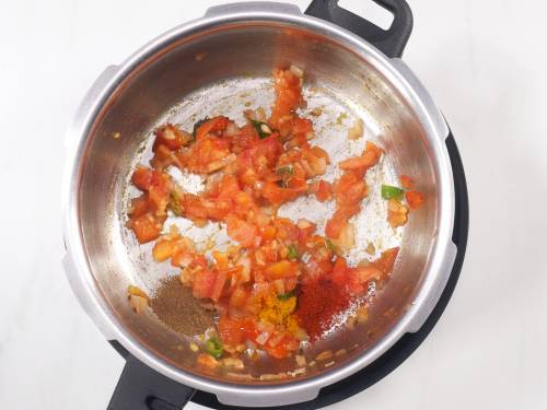 adding spice powders to make moong dal