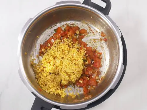 rinsed moong dal being added to cooker