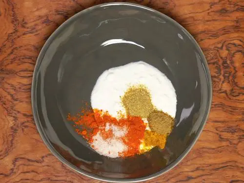 yogurt and spices in a bowl to make paneer tikka