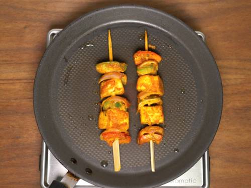 grilling paneer tikkas on a griddle