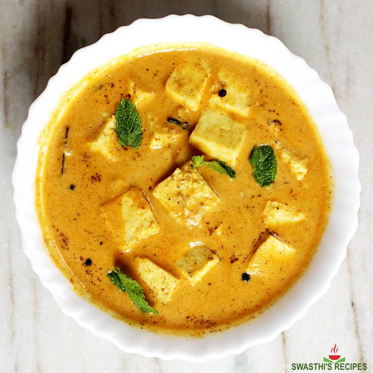 shahi paneer also known as mughlai paneer served in a white bowl