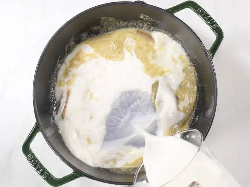 pour milk to make spinach soup