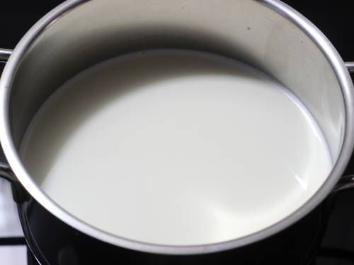 boiling milk in a pot to make basundi