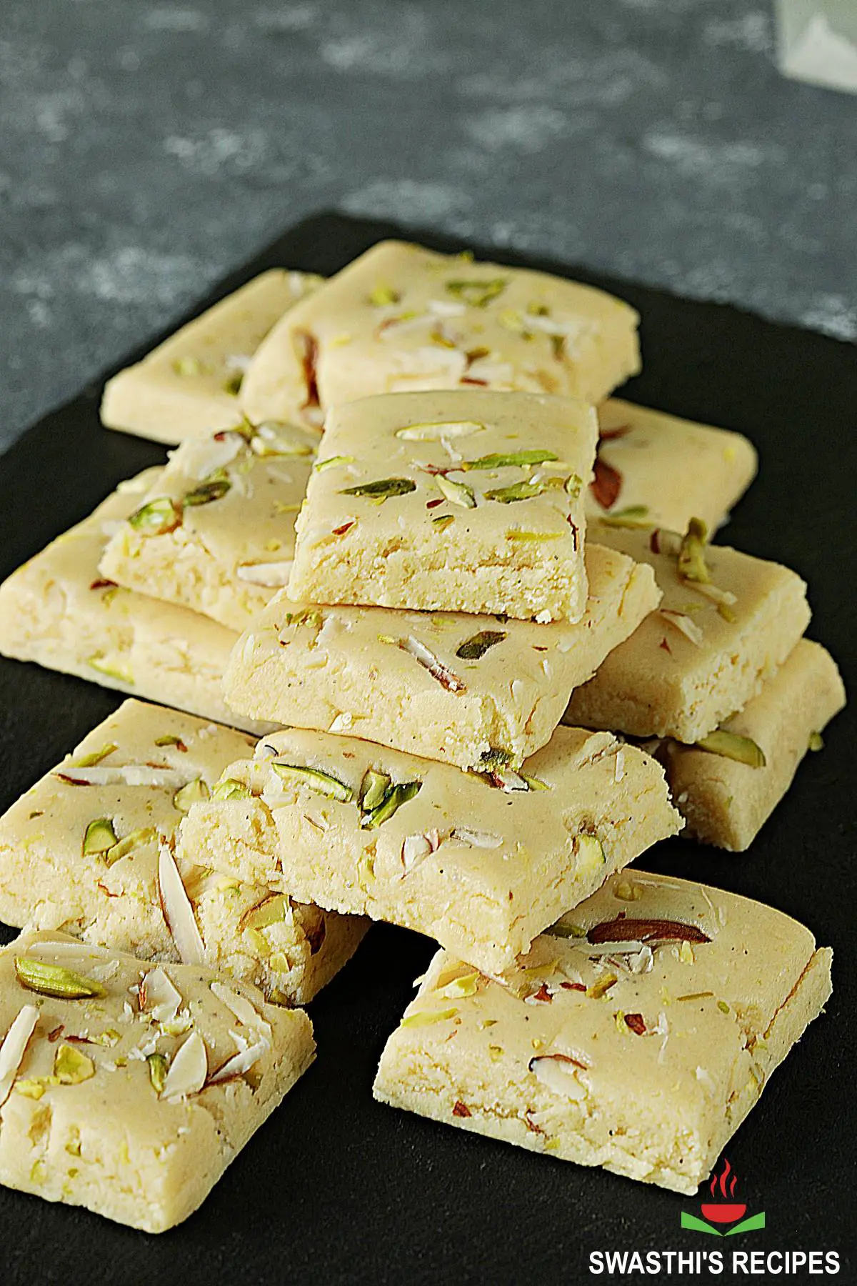 milk powder barfi on a black slate