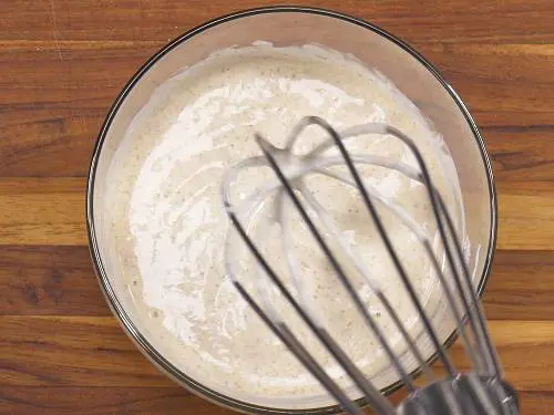 whisk yogurt in a bowl to make mint chutney