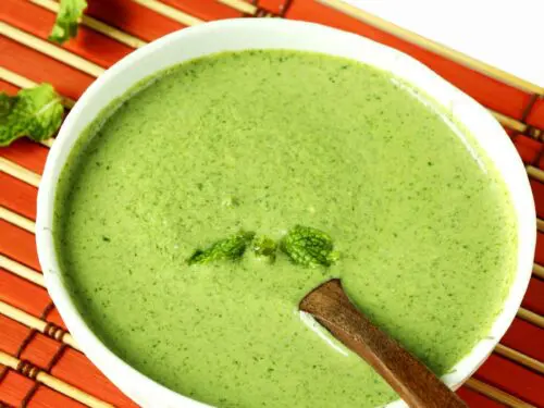 Pudina chutney also known as mint chutney served in a white bowl